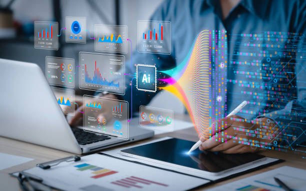 Analyst working across a laptop and tablet while holographic charts and data streams fan out above the desk