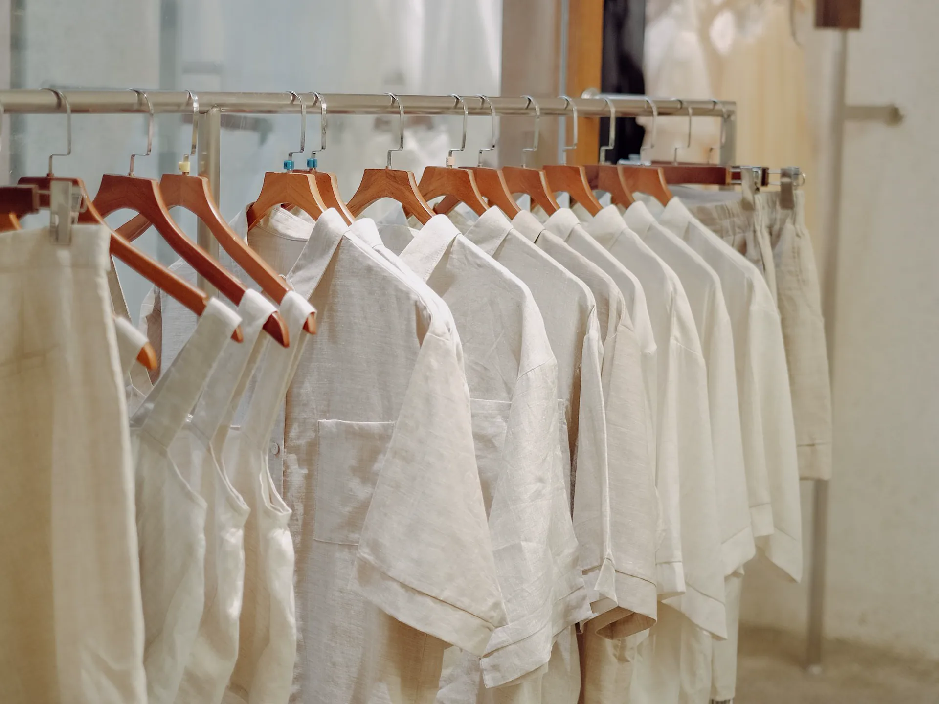 Rows of garments hanging on a rack inside a fashion boutique