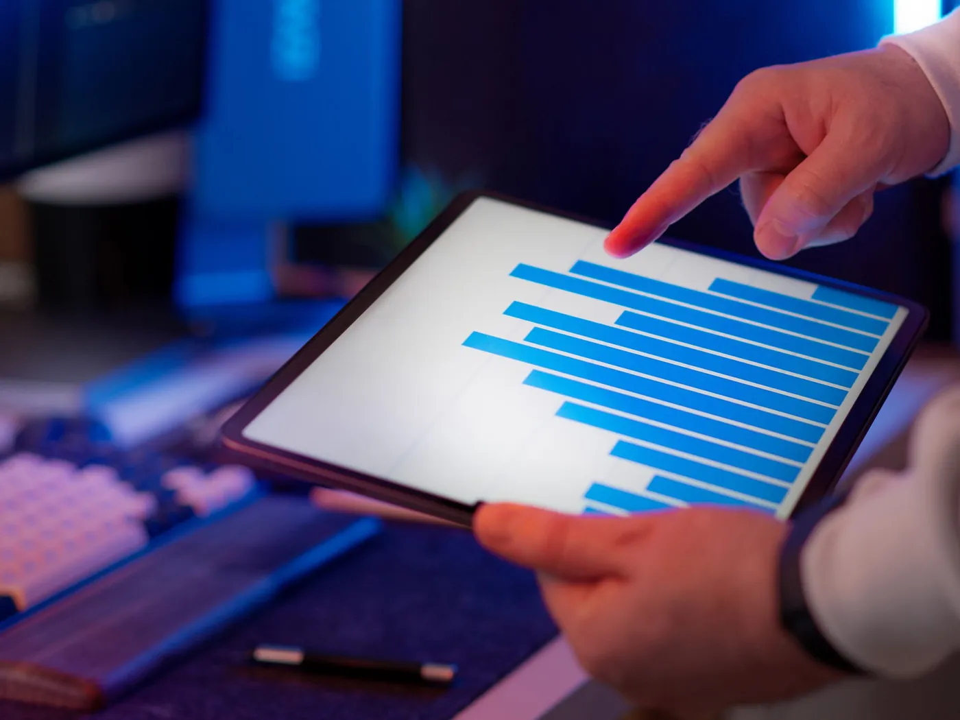 A finance lead reviewing performance figures on a tablet