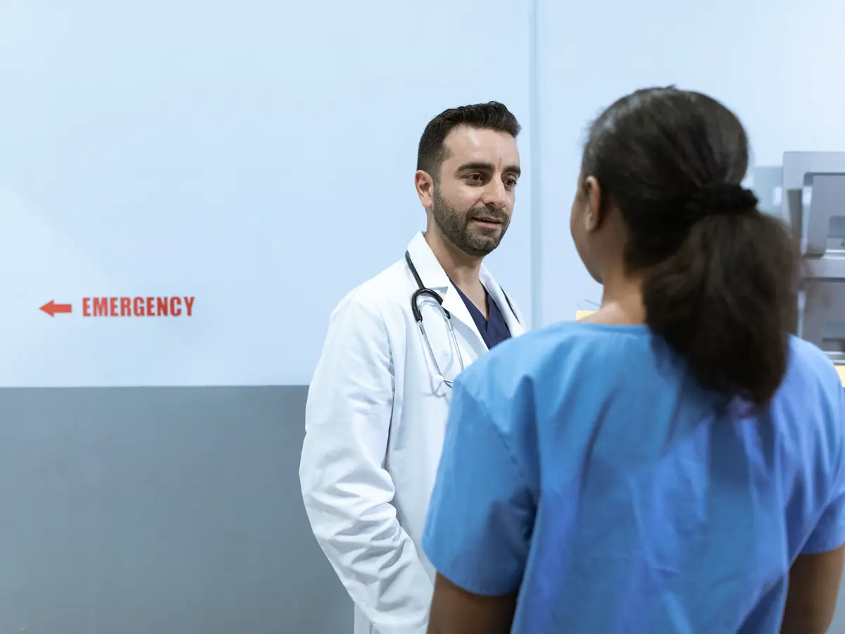 Healthcare workers in discussion during a ward meeting