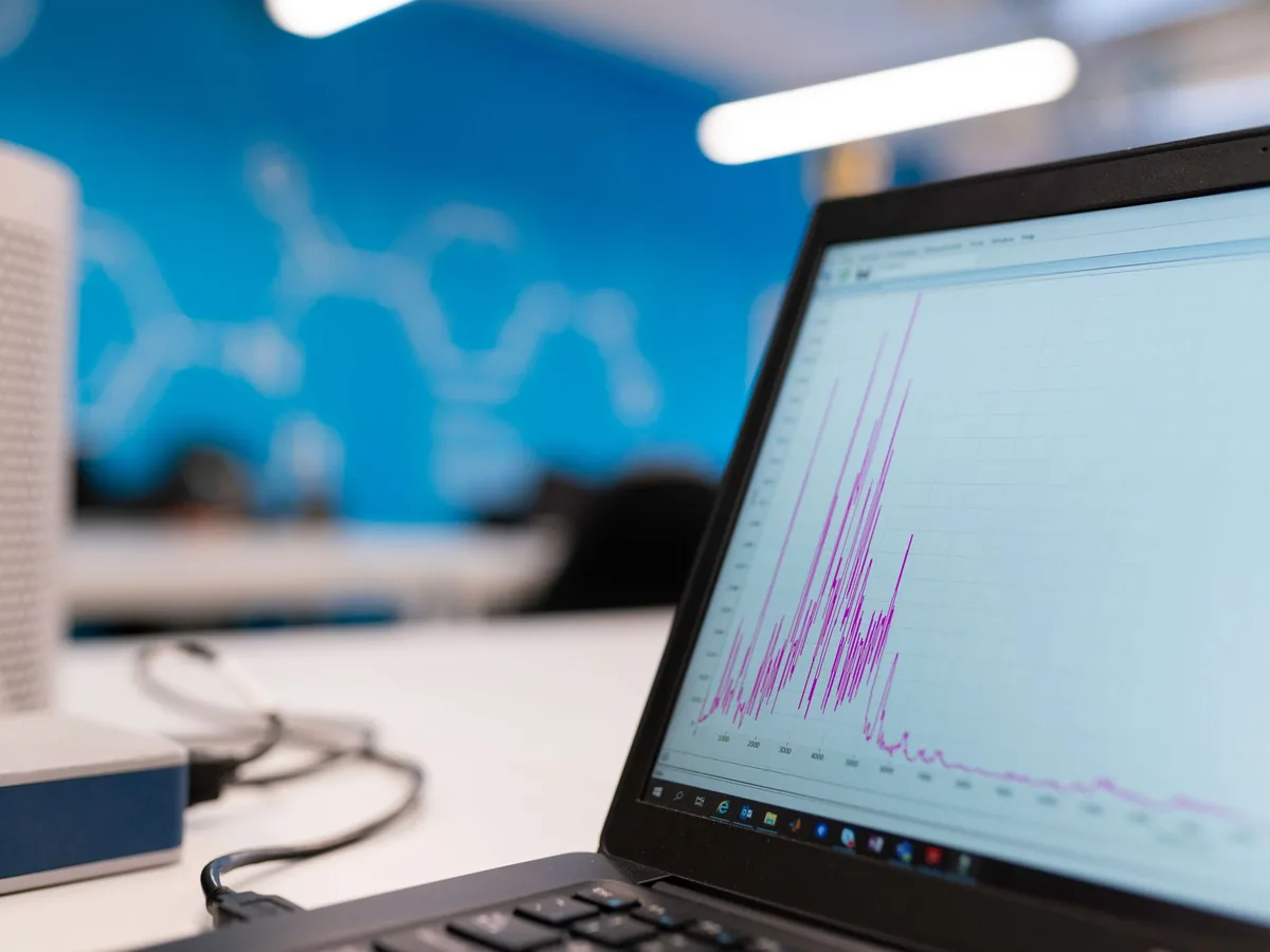 A laptop showing property performance charts on a desk