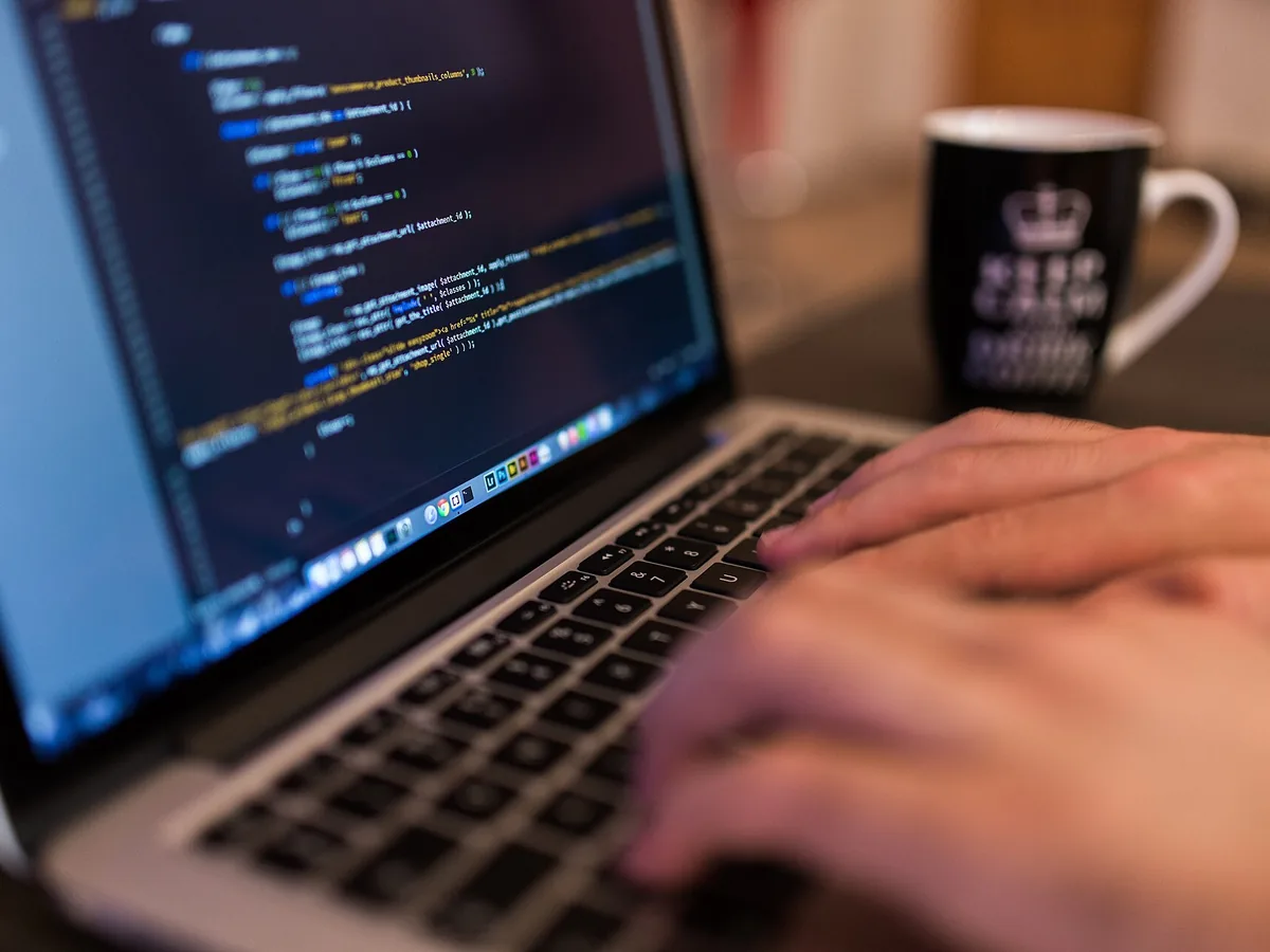 A development team working across a bank of monitors
