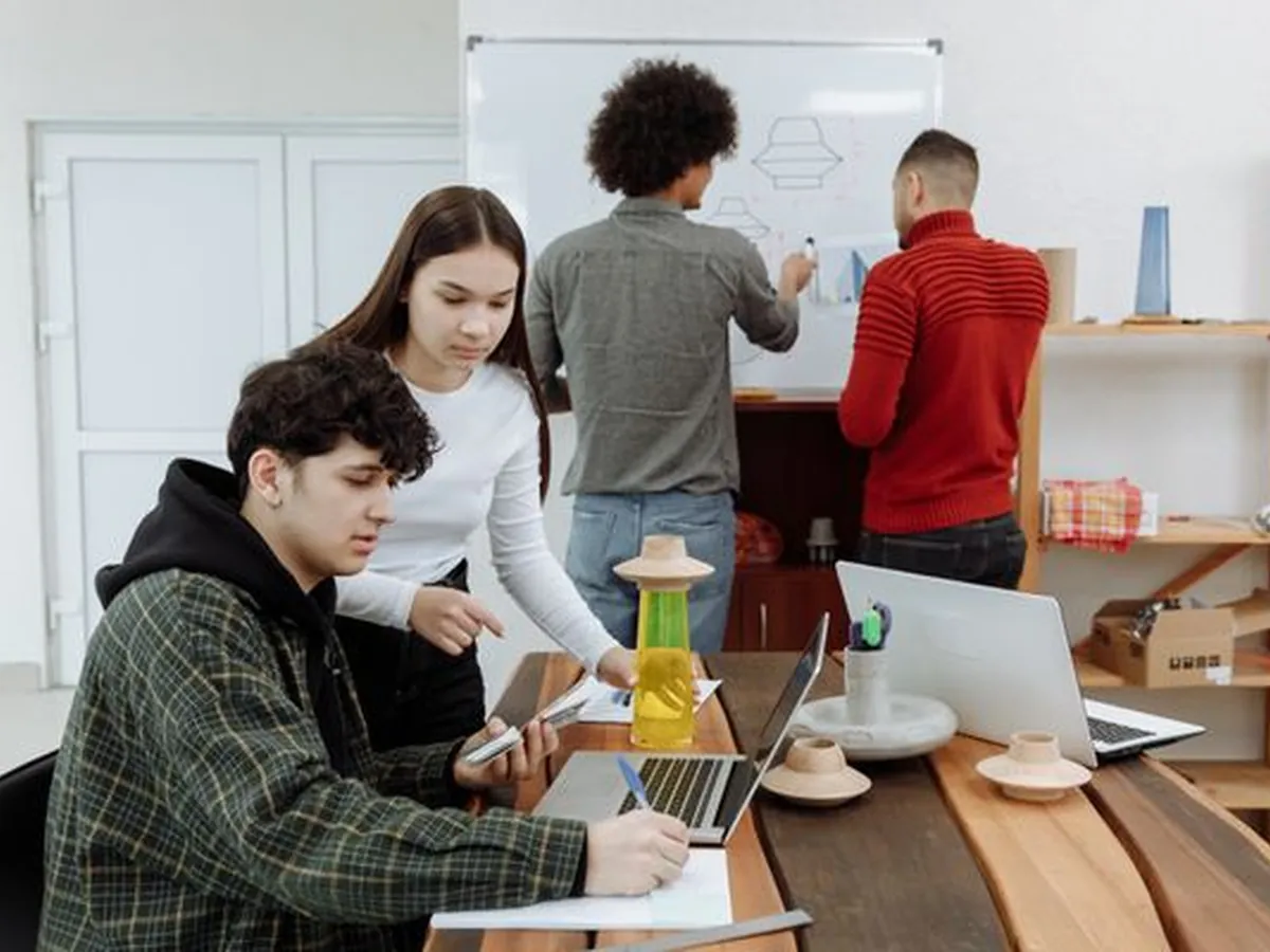 A product team mapping a build on a studio whiteboard
