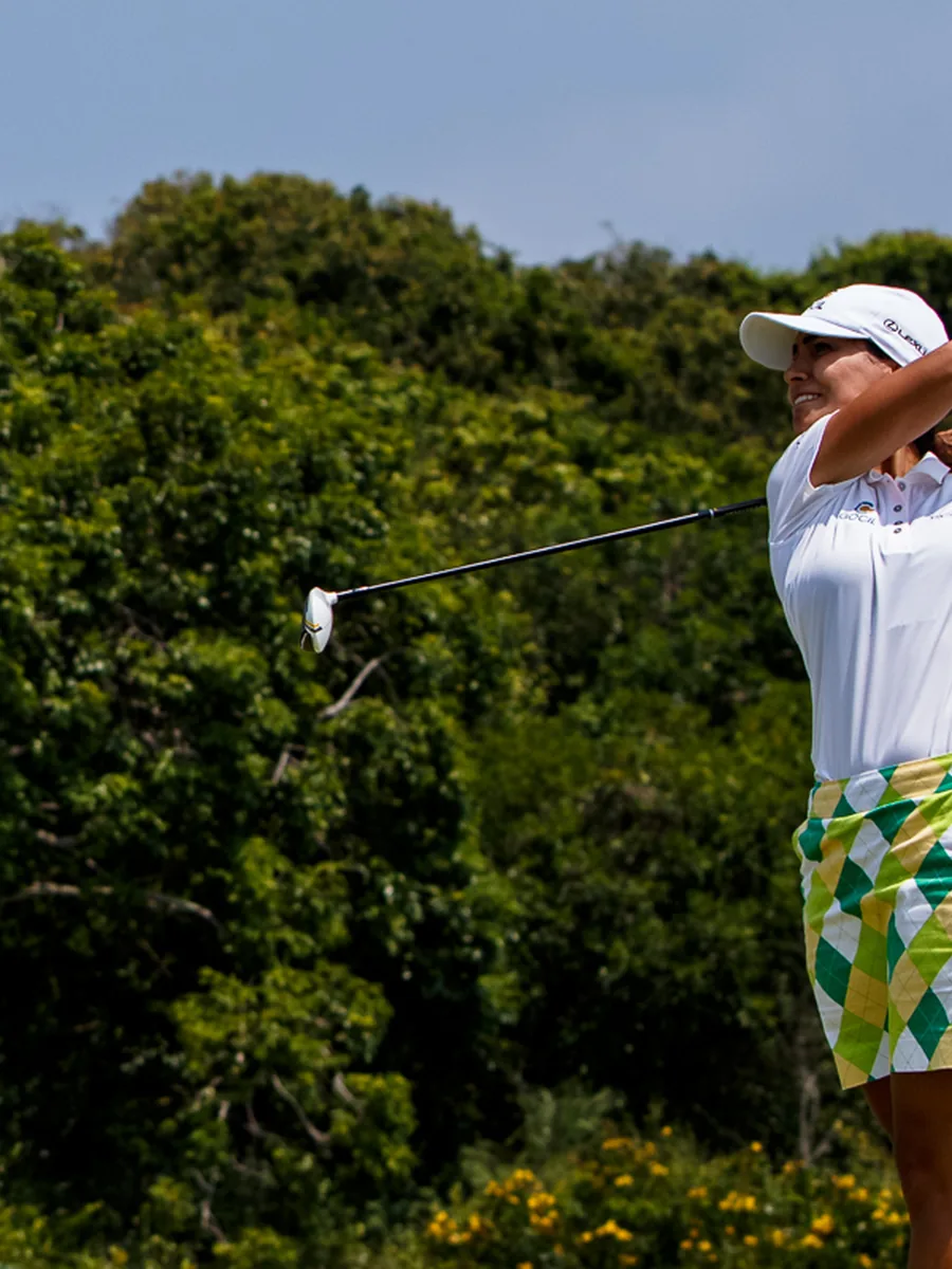 A golfer following through on a fairway shot