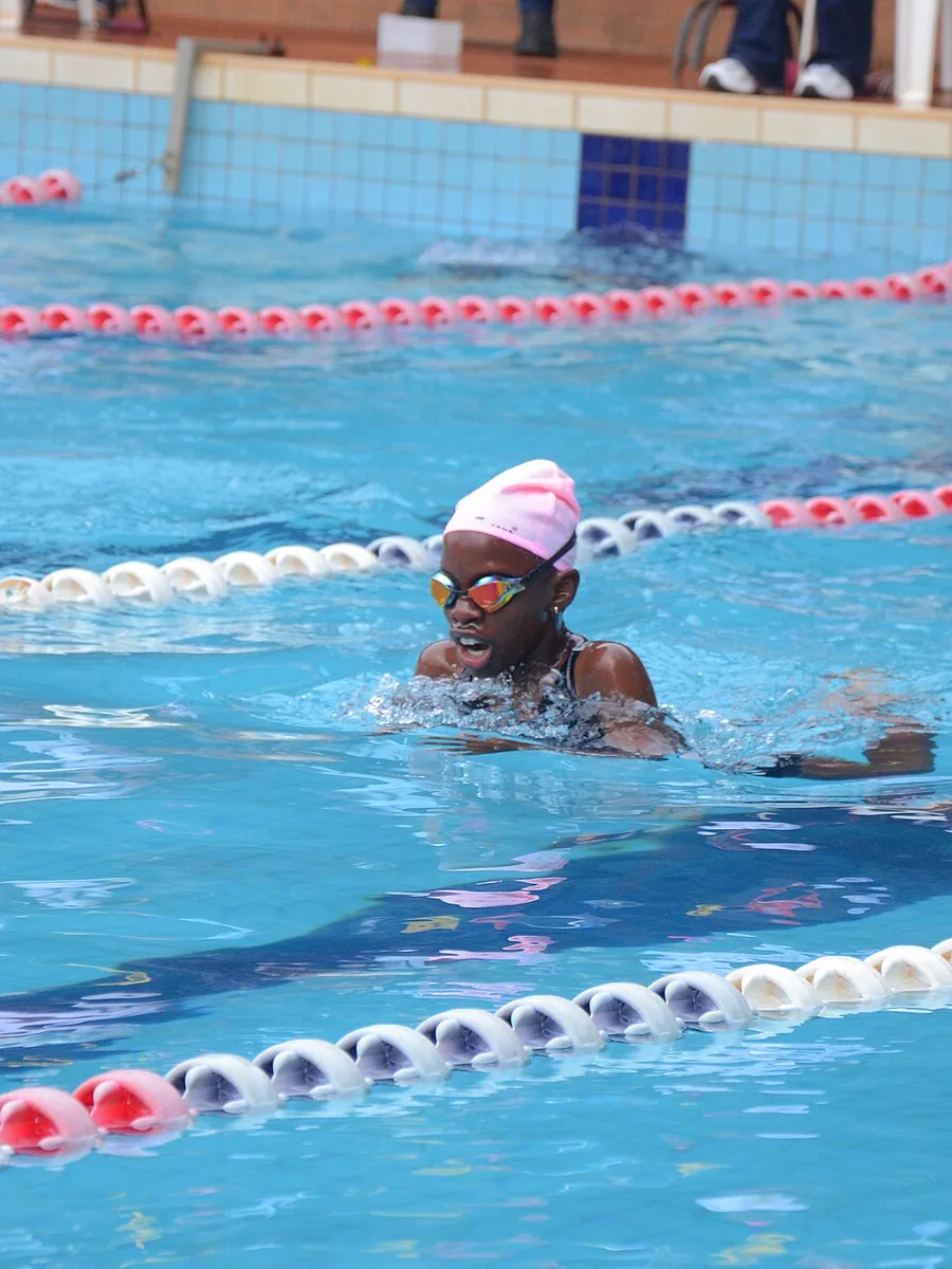 A swimmer mid-stroke in a competition lane
