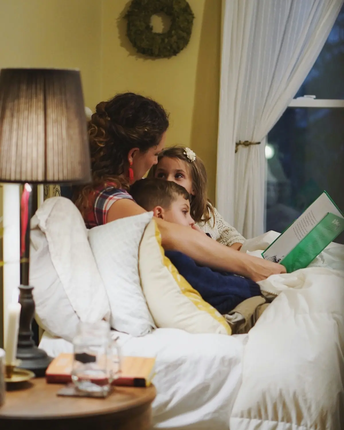 A parent reading with a child at home