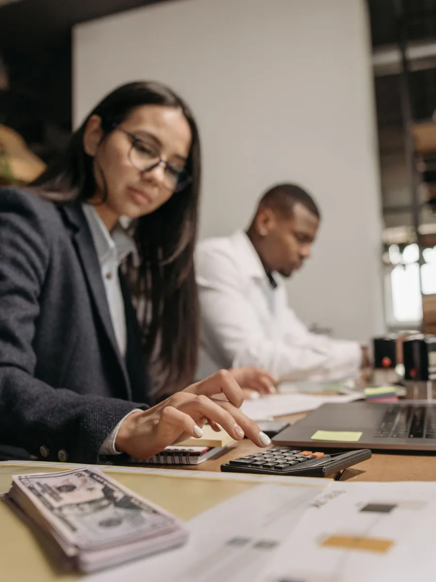 Two accountants reviewing figures on a laptop