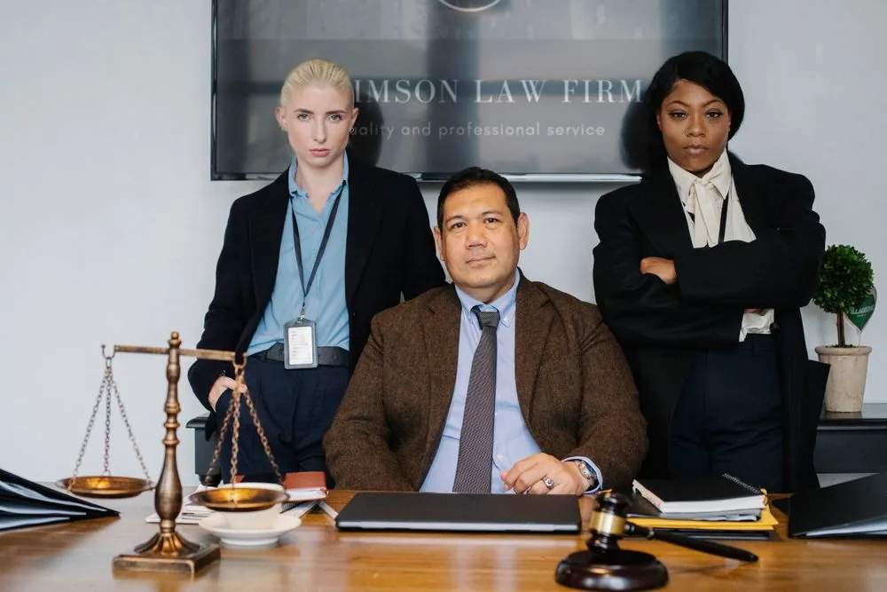 Colleagues at a table with a gavel in a law office