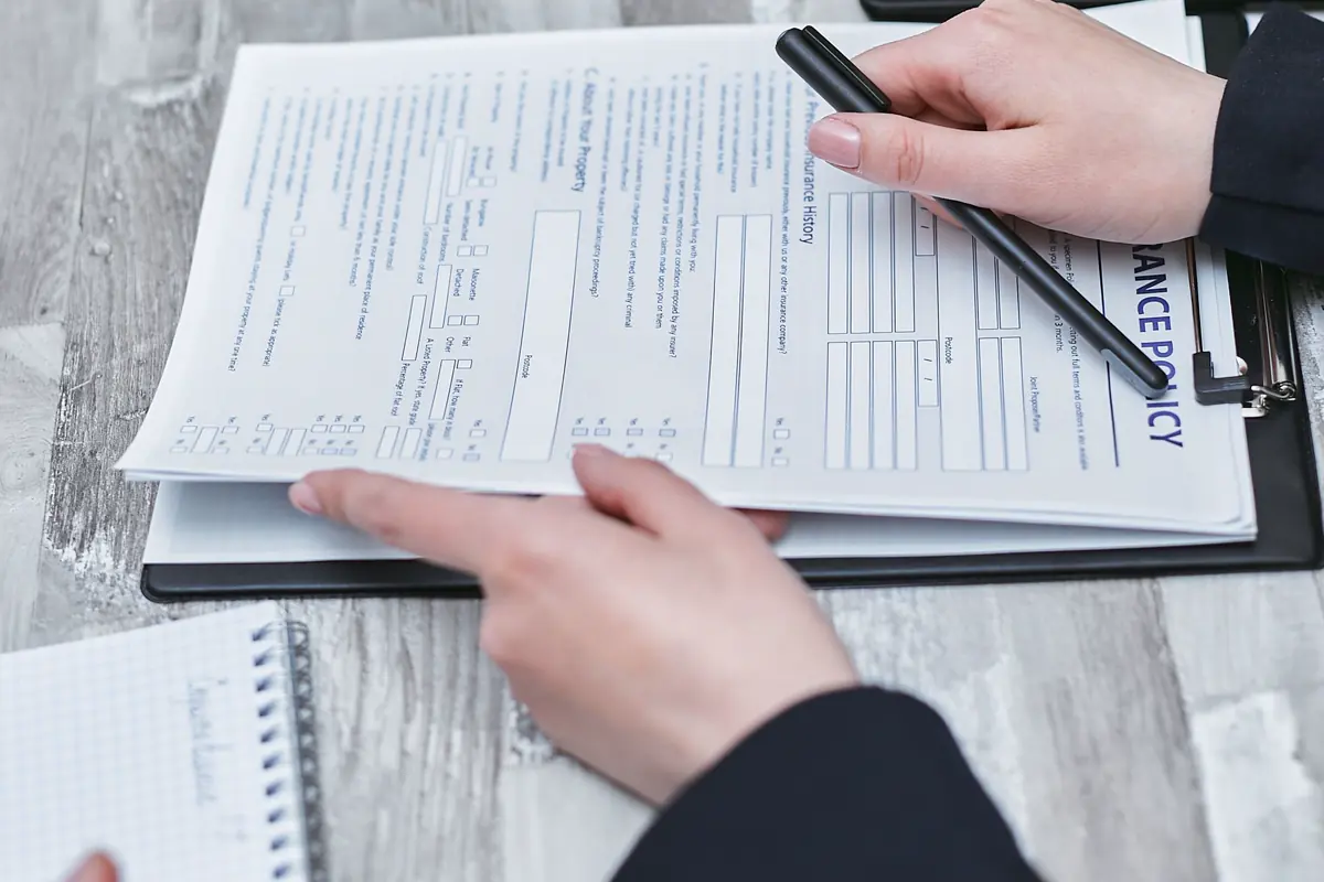 Hands reviewing an insurance policy document
