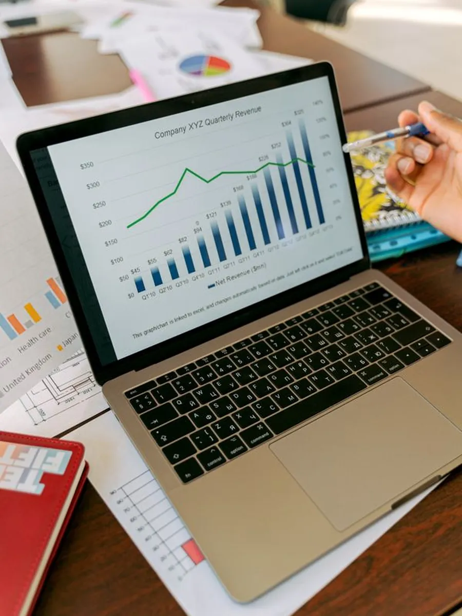 A performance marketer reviewing campaign charts on a laptop