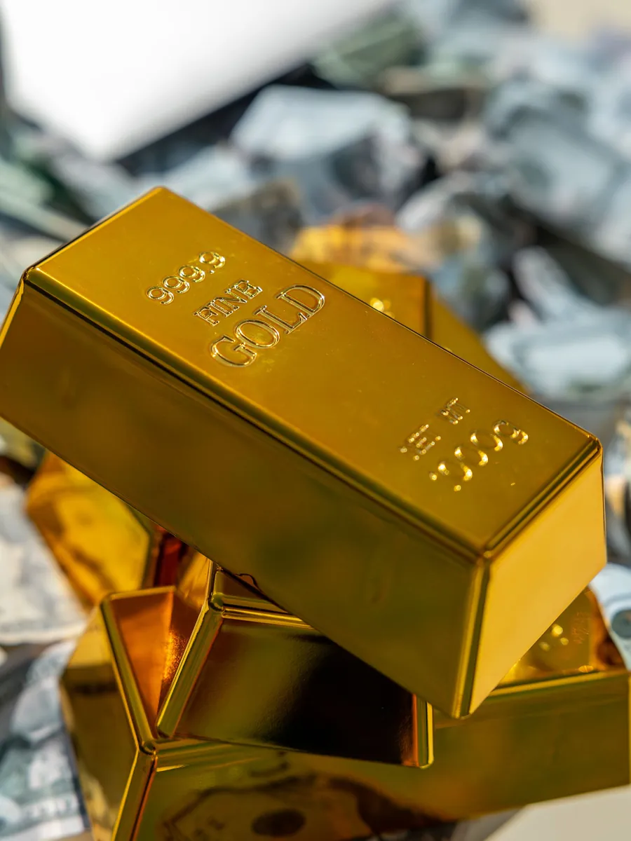 Gold bars stacked on currency notes