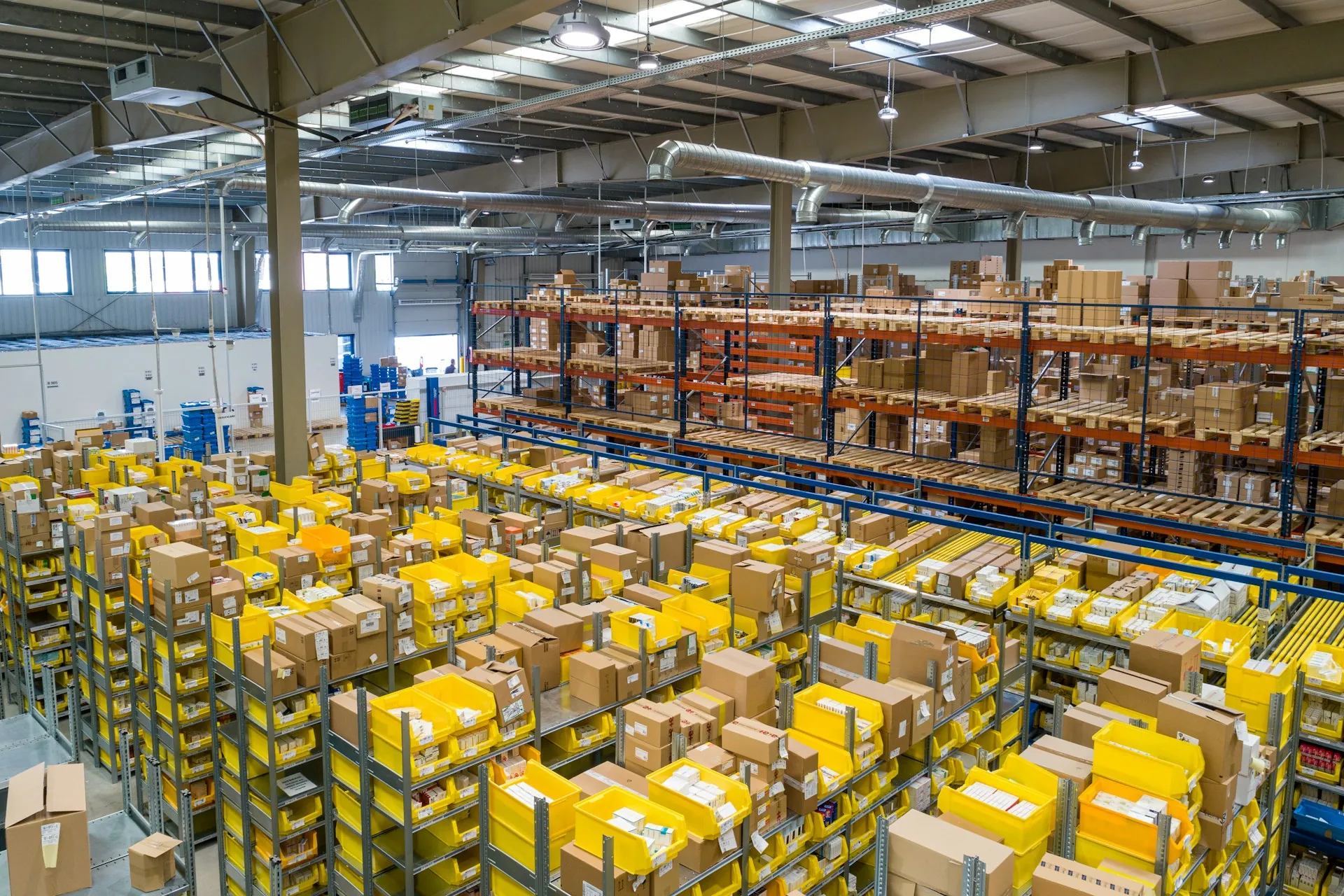 A fulfilment warehouse floor stacked with parcels between tall racking