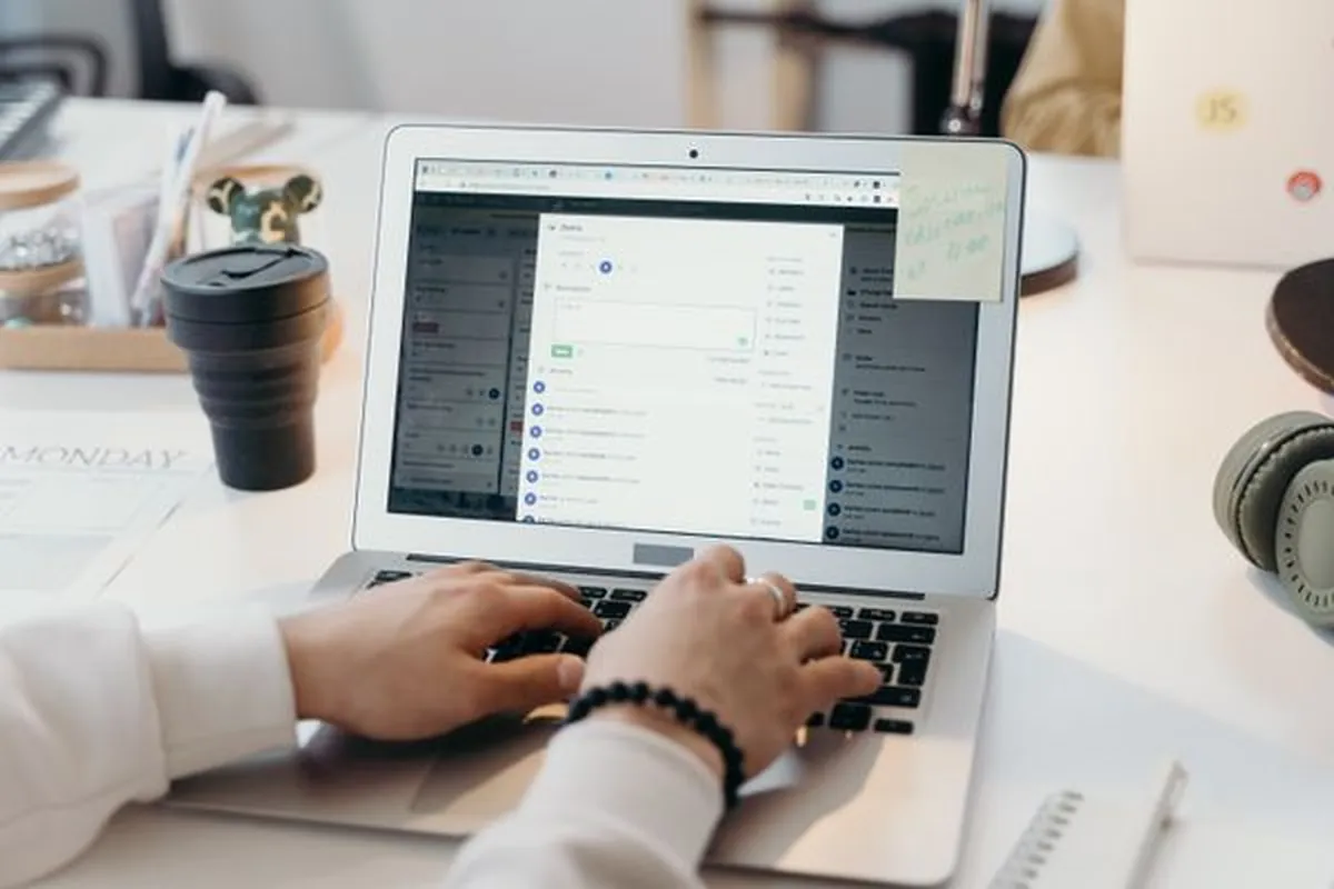Hands typing an email campaign on a laptop
