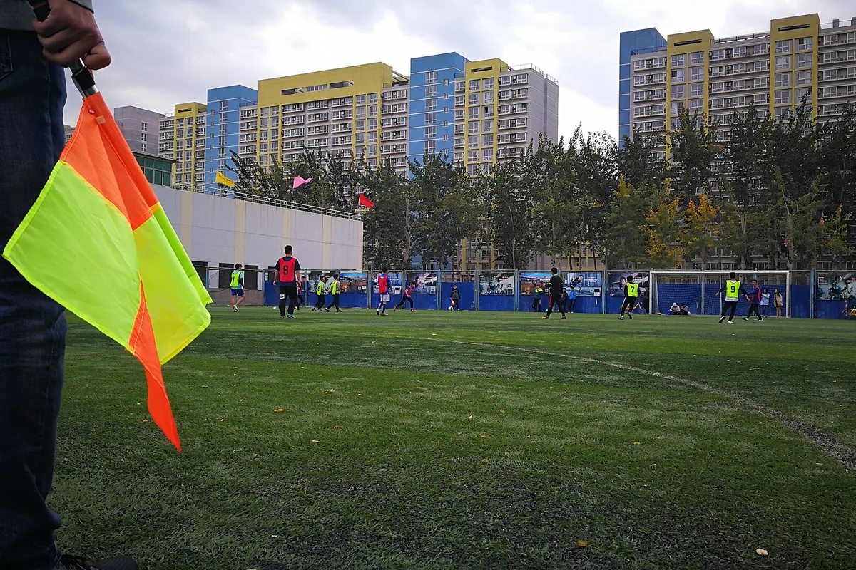 A referee signalling during a football match