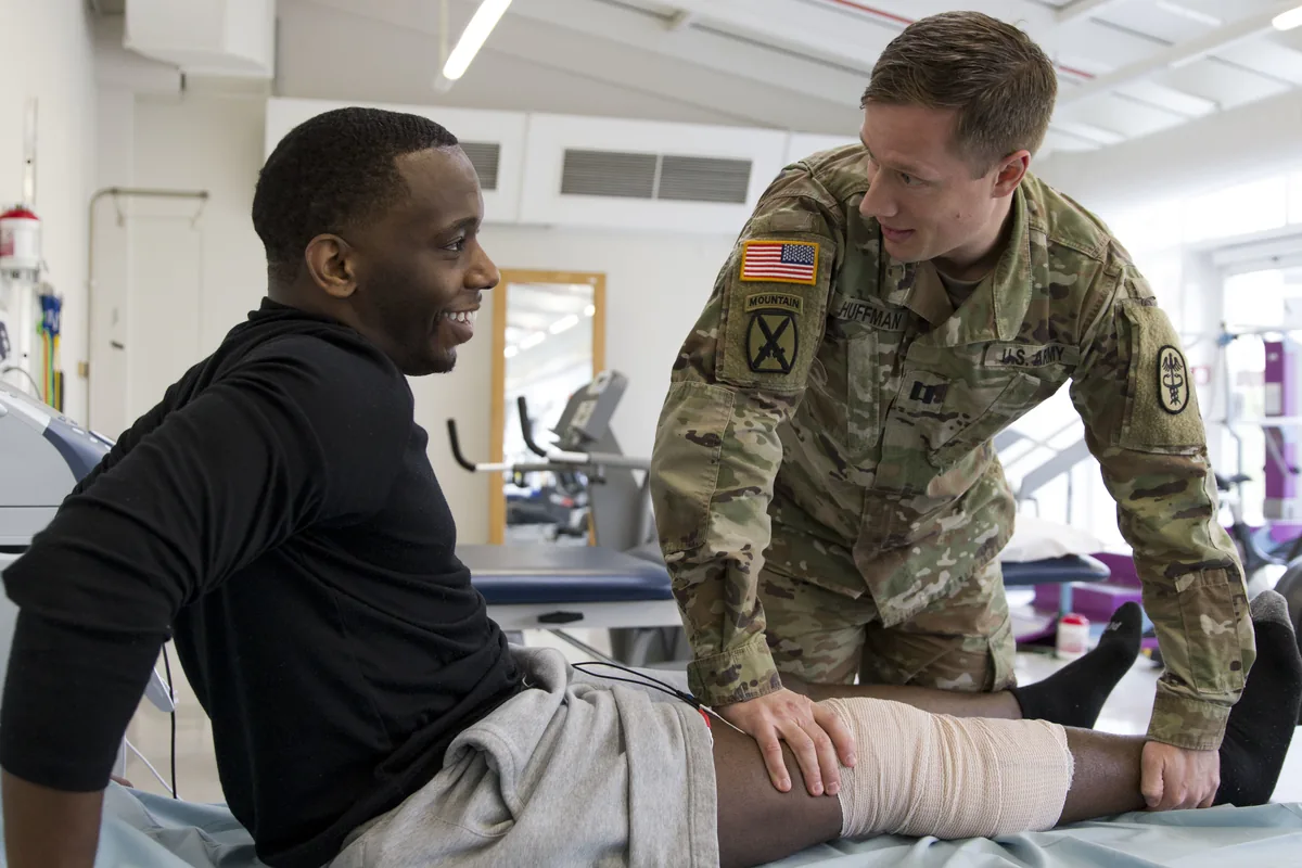 A physiotherapist treating an athlete's knee