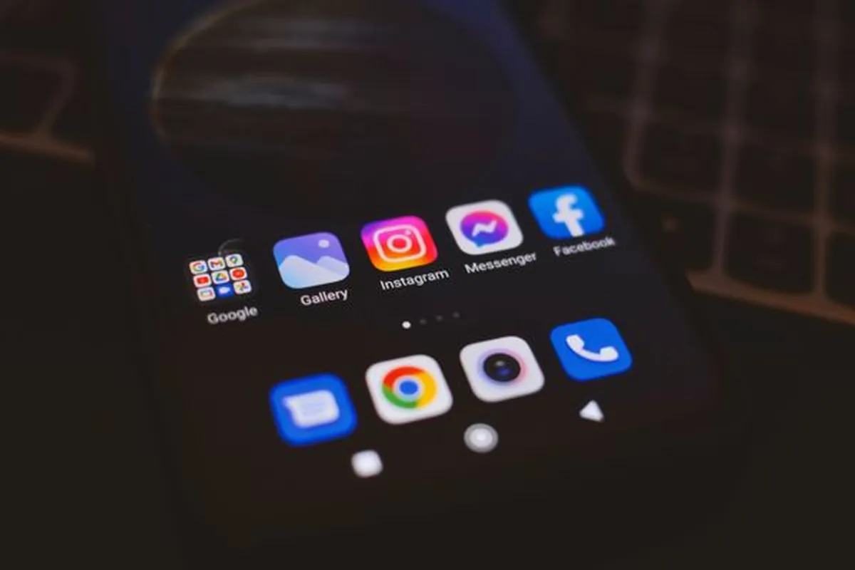 Social app icons glowing on a smartphone screen