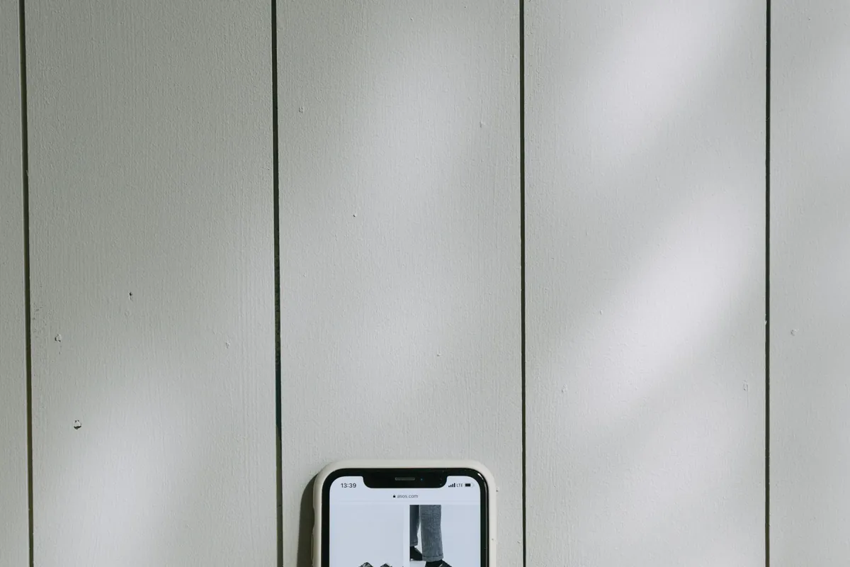 A smartphone wallet app beside a payment card