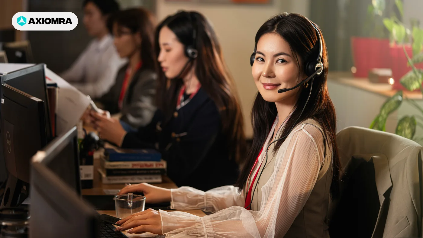 Support staff on headsets at their desks handling first responses by hand