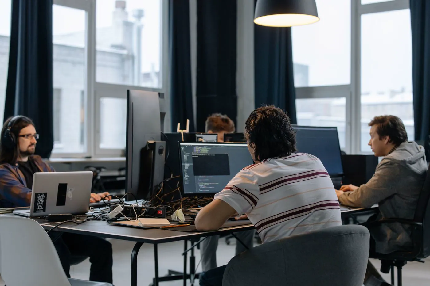 Axiomra engineers working side by side at their monitors in the studio